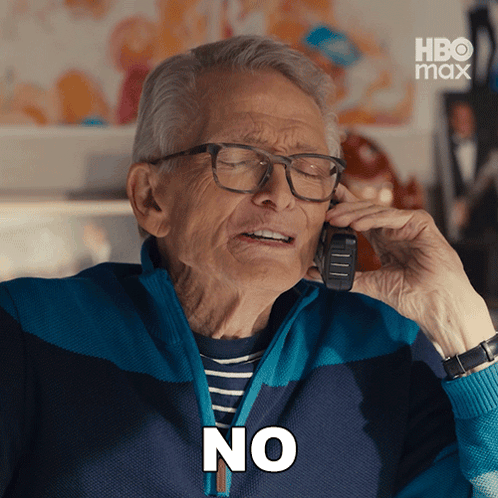 Older Man With Glasses Talking on Phone Saying No