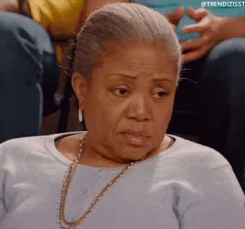 Older Woman In Blue Shirt And Gold Necklace GIF