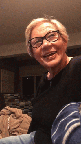 Older Woman in Glasses and Black Shirt Smiling