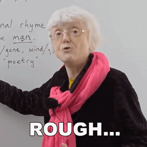 Older Woman in Glasses and Pink Scarf Saying Rough