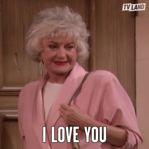 Older Woman in Pink Jacket Says I Love You