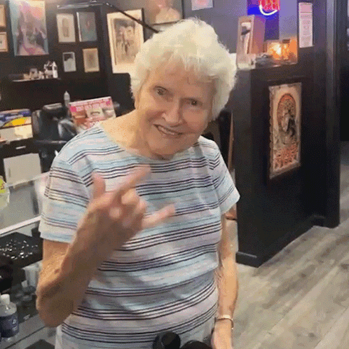 Older Woman in Striped Shirt Giving Middle Finger