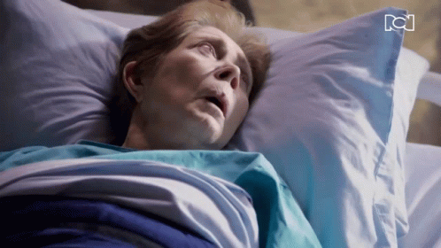 Older Woman Laying in Hospital Bed With RC Letters