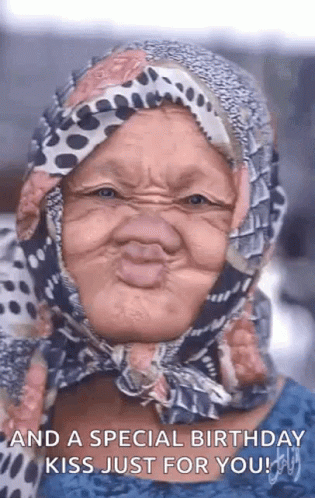 Older Woman Making Funny Face And Birthday Kiss GIF