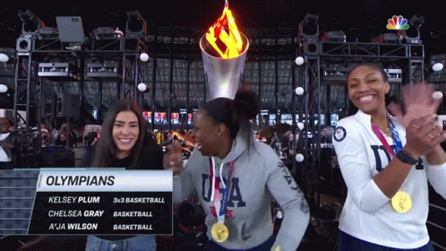 Olympians Kelsey Plum Chelsea Gray And A Ja Wilson Are Standing In Front Of The Torch GIF