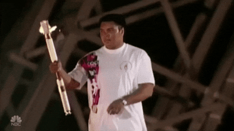 Olympic Man Lights Torch GIF