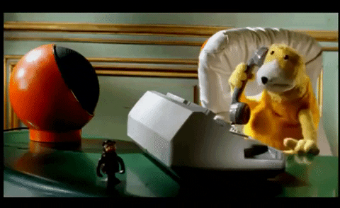 On Hold Yellow Puppet In Table GIF
