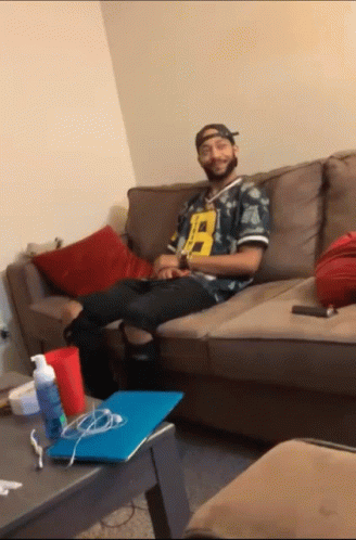Man Oop Reaction While Seating On The Couch GIF