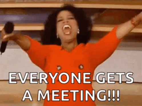 Oprah Winfrey Holding Microphone Saying Everyone Gets a Meeting