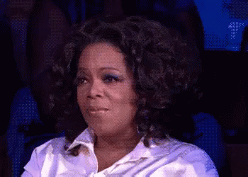 Oprah Winfrey Is Sitting In A Chair With Her Eyes Closed And Making A Funny Face . GIF