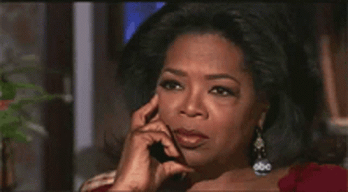 oprah winfrey talking on a cell phone with her hand on her chin