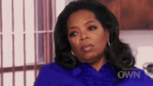 Oprah Winfrey Wearing Blue Shirt and Earrings