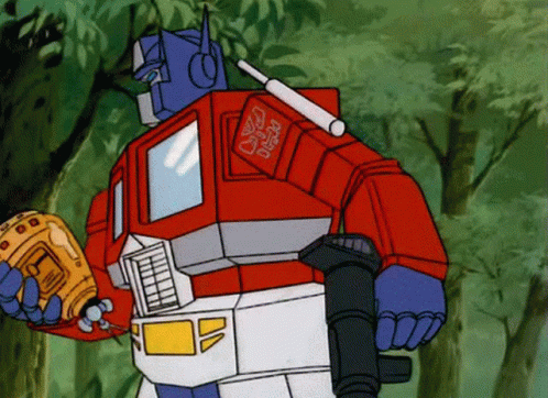 Optimus Prime From The Transformers Holding A Gun GIF