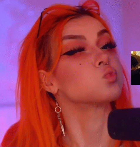 Orange-Haired Woman Blowing Kiss Earrings Nose Ring