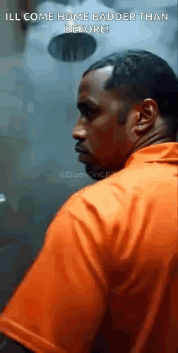 Orange Shirt Man In Prison Cell Looking At Camera GIF