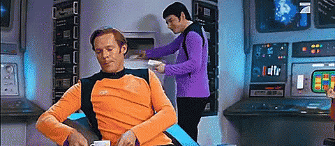 Orange Shirt Man Sits, Purple Shirt Man Works