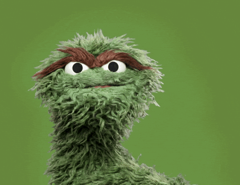 oscar the grouch from sesame street is covering his face with his hand