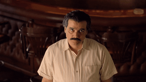 Pablo Escobar Chewing And Staring GIF