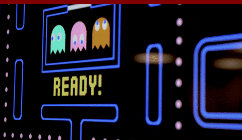 Asian Guy Playing Pac Man On Big Screen GIF