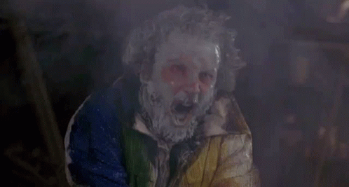 Paint-covered Person in Clown Mask and Colorful Jacket