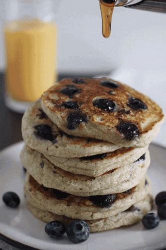 Pancake Stack with Blueberries and Syrup Pouring