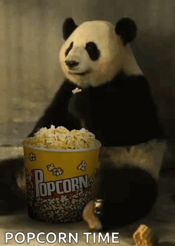 Panda Bear Sitting Next to Popcorn Bucket