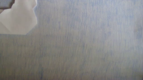 Paper Airplane Folded in Half on Blue Surface