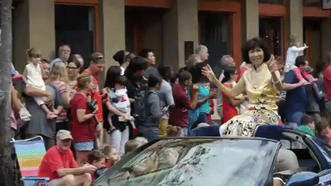 Parade Woman Sitting In Car Roof GIF