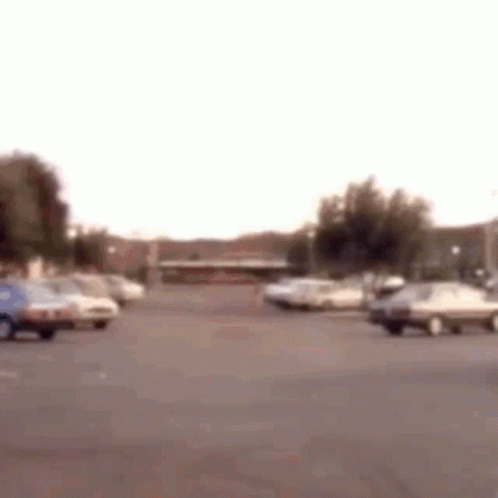 Parking Lot With Cars And Building GIF