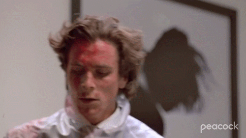 Patrick Bateman Removing Bloodied Gown GIF