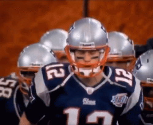 Patriots Players In Huddle With Helmets GIF