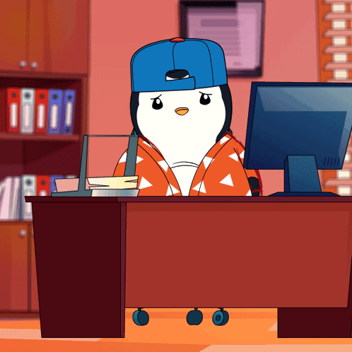 Penguin in Blue Hat at Desk with Computer