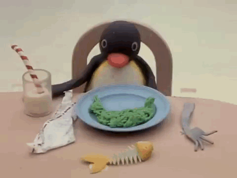 Penguin Sitting at Table with Food and Milk