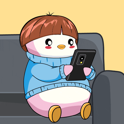 Penguin Sitting on Couch Looking at Phone