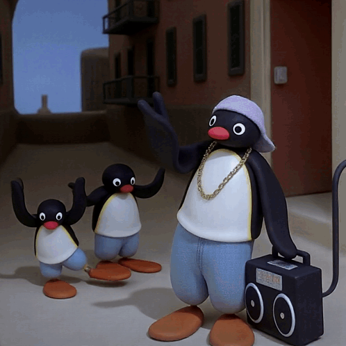 Penguin with Chain Standing Next to Two Penguins and Boombox