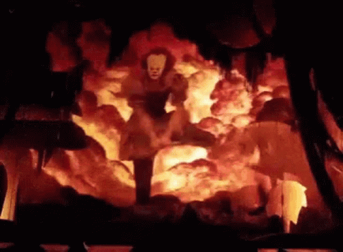 Pennywise Standing in Cave Surrounded by Flames