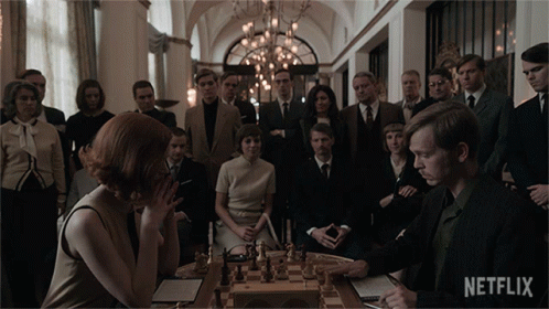 People Around Chess Board With Netflix Logo GIF