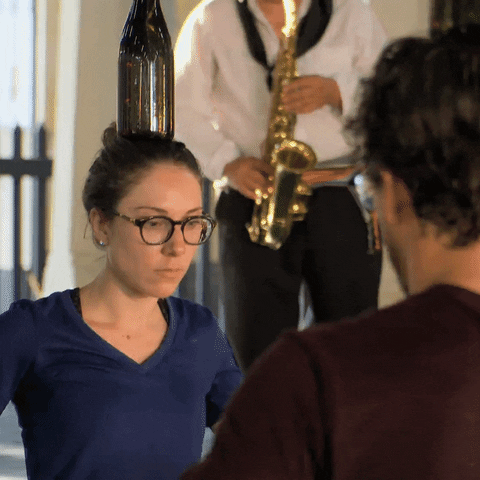 People Balance Bottles On Their Heads GIF