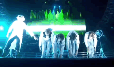 People Bending Over on Green Stage