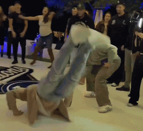 People Dancing by Ford Sign