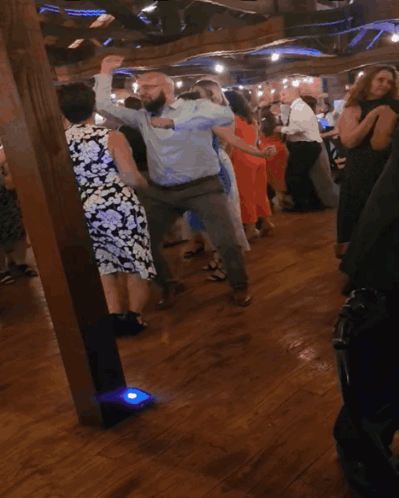 People Dancing in Blue Light