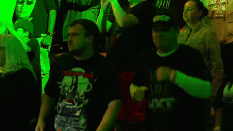 People Dancing in Dark Room With Green Lights