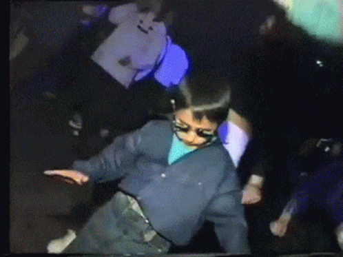 People Dancing in Dark Room with Sunglasses