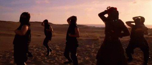 People Dancing In Desert At Sunset GIF
