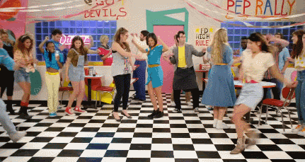 People Dancing In Diner With Pep Rally Sign GIF
