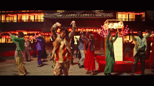 People Dancing in Front of Building With 000