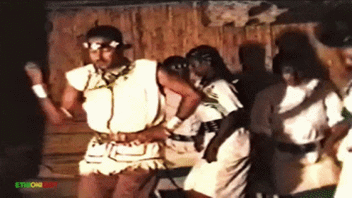 People Dancing In Front Of Ethiopian Sign GIF