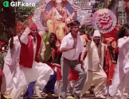 People Dancing in Front of Ganesha Statue