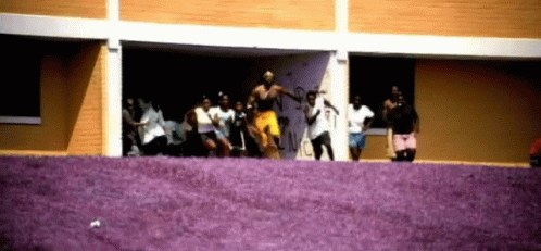 People Dancing In Front Of Graffiti Building GIF