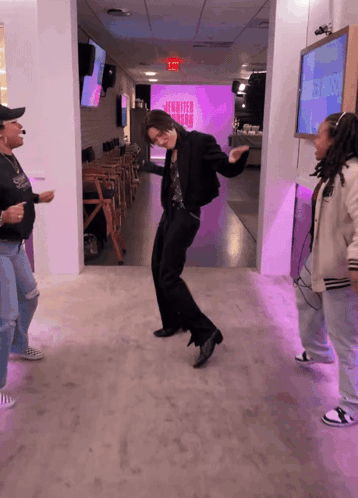 People Dancing in Front of Jennifer Aniston Screen